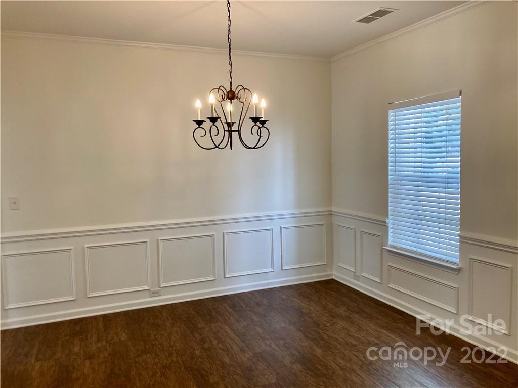 6432 Hermsley Road Charlotte, NC 28278 - Photo 4 of 32 a view of an empty room with wooden floor and a window