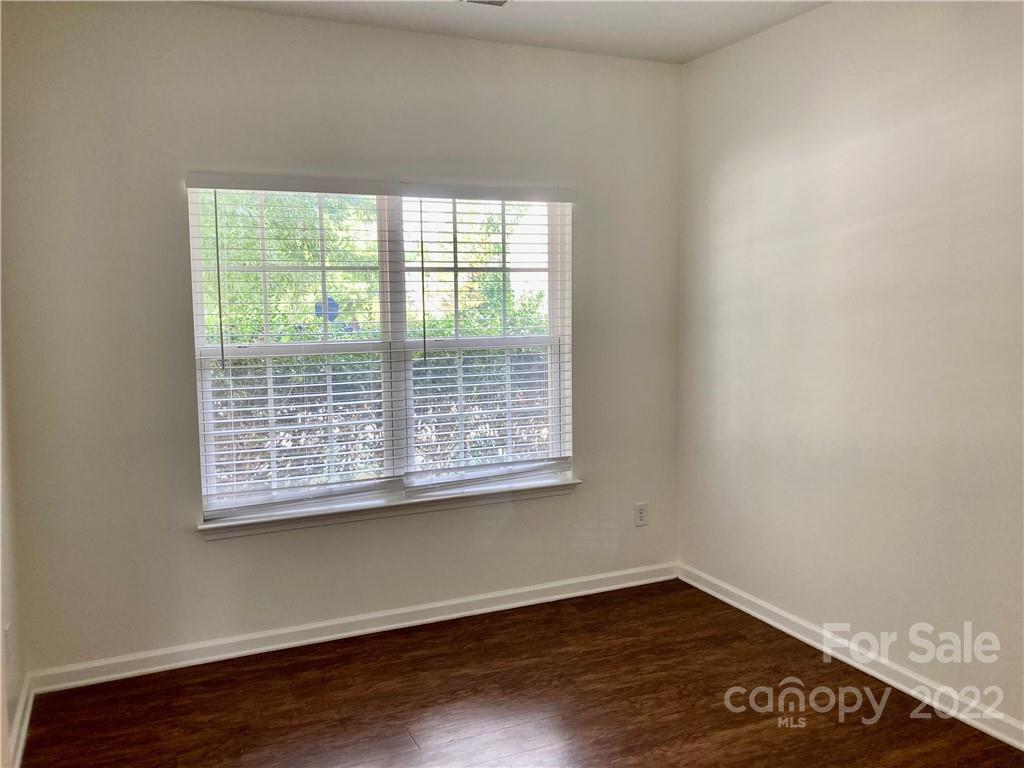 6432 Hermsley Road Charlotte, NC 28278 - Photo 5 of 32 a view of an empty room with wooden floor and a window