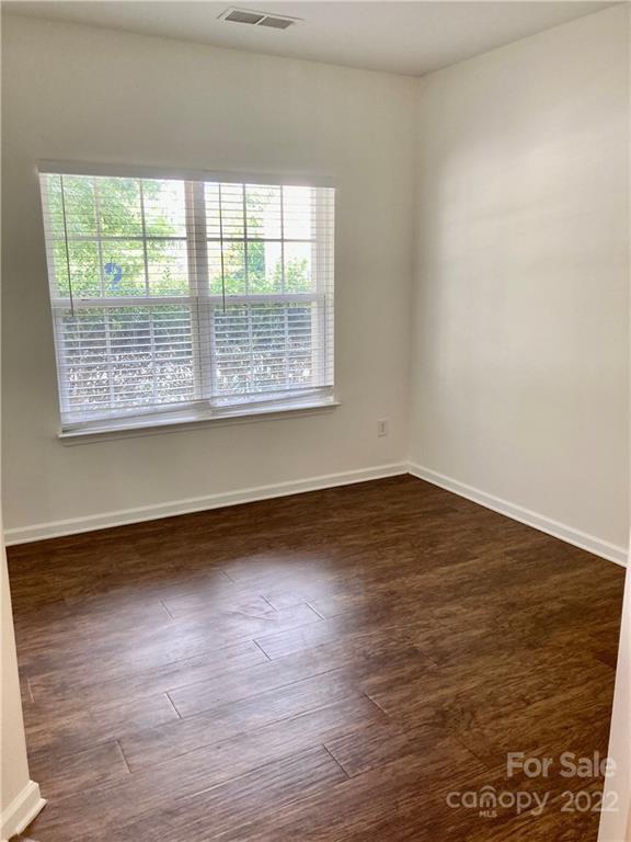6432 Hermsley Road Charlotte, NC 28278 - Photo 6 of 32 an empty room with wooden floor and windows