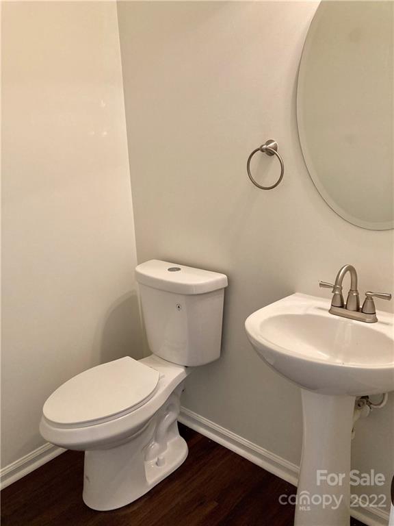6432 Hermsley Road Charlotte, NC 28278 - Photo 7 of 32 a white toilet sitting next to a bathroom sink