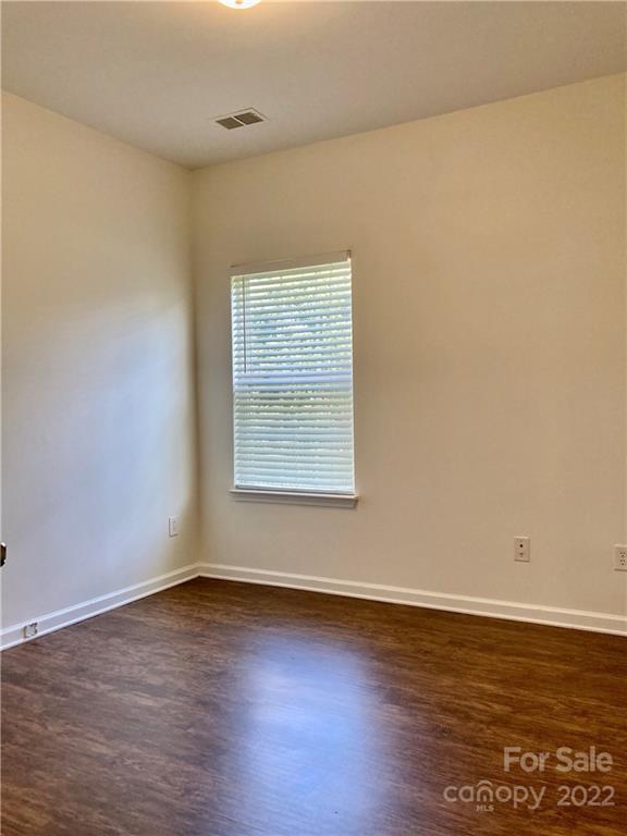 6432 Hermsley Road Charlotte, NC 28278 - Photo 9 of 32 an empty room with wooden floor and windows