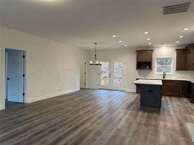 a large kitchen with a wooden floor and a sink
