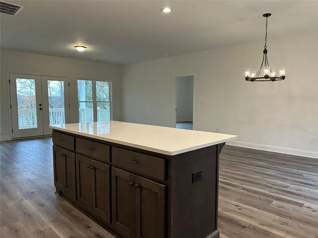 a kitchen with a wooden floor and a wooden floor
