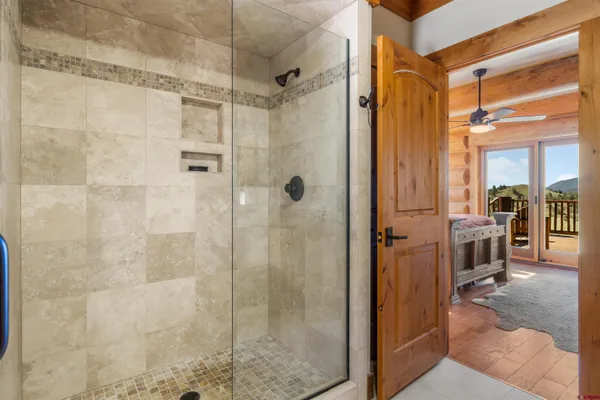 a bathroom with a glass shower door
