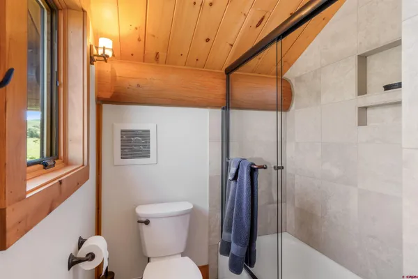 a bathroom with a toilet and a shower