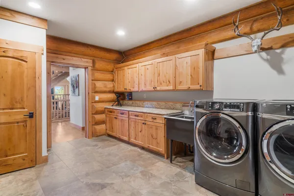a utility room with sink dryer and washer