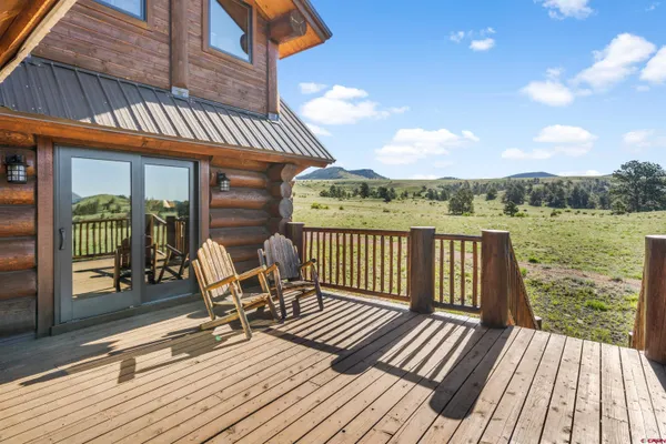 a view of a roof deck with chair and wooden floor