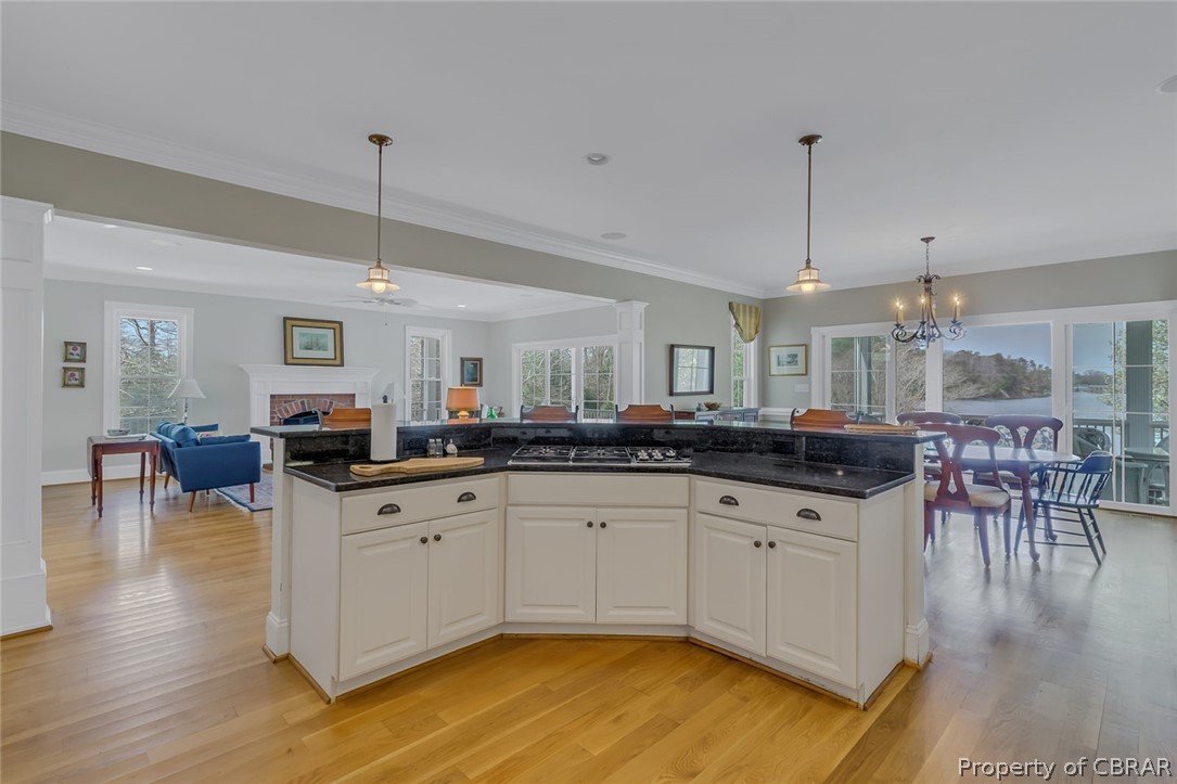 507 Sunnybank Road Reedville, VA 22539 - Photo 26 of 48 Kitchen featuring light wood-type flooring, hanging light fixtures, and white cabinetry