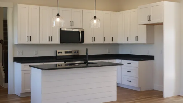 a kitchen with stainless steel appliances a stove top oven a sink and a fireplace