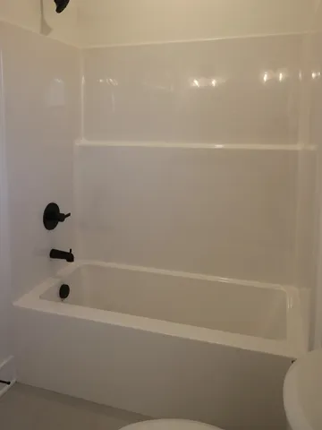 a bathroom with a shower and mirror