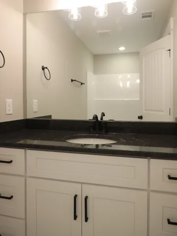 a view of a room with a ceiling fan