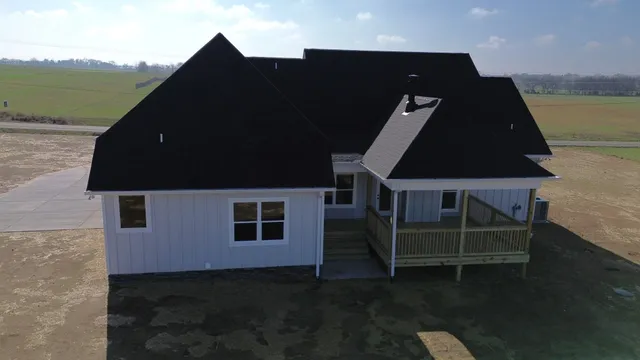 aerial view of a house with a yard
