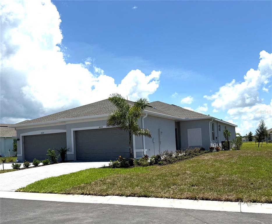 8694 Seasalt Loop Englewood, FL 34224 - Photo 1 of 1 a view of a house with a yard and a large tree