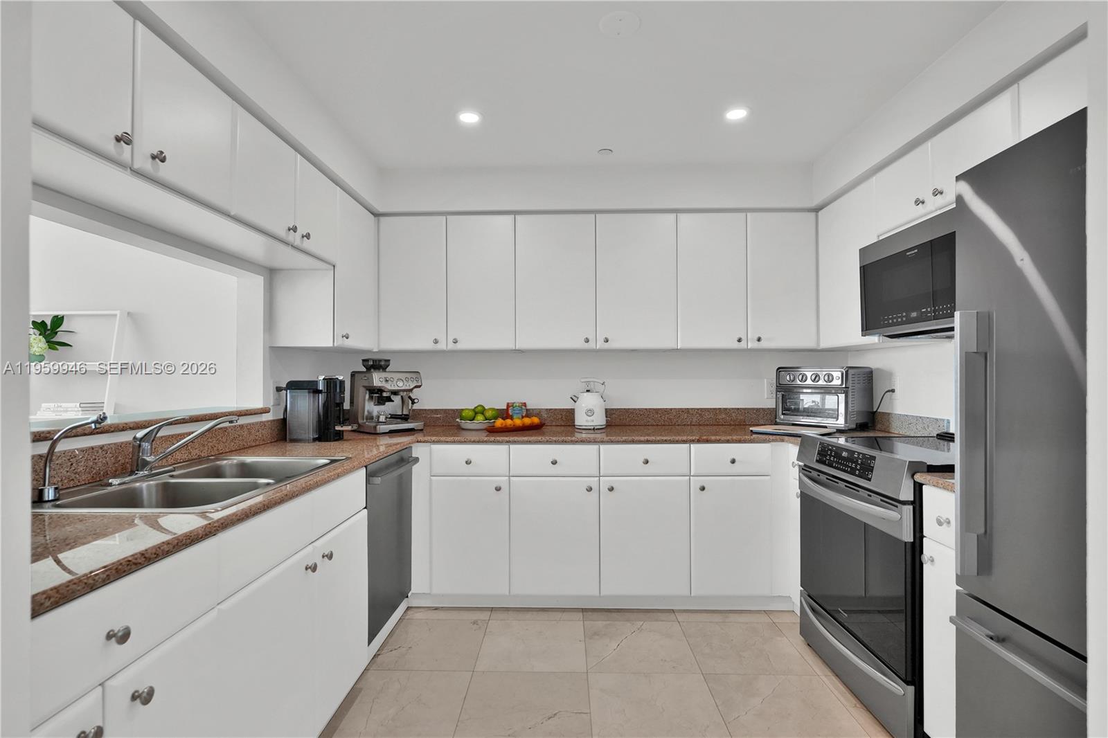 2475 Brickell Avenue, Unit 1509 Miami, FL 33129 - Photo 12 of 32 Kitchen with Stainless Steel Appliances & Gourmet Coffee Machine