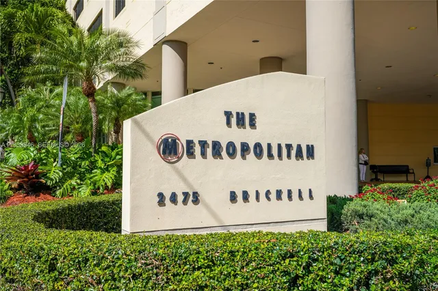 a living room with furniture potted plant and a large window