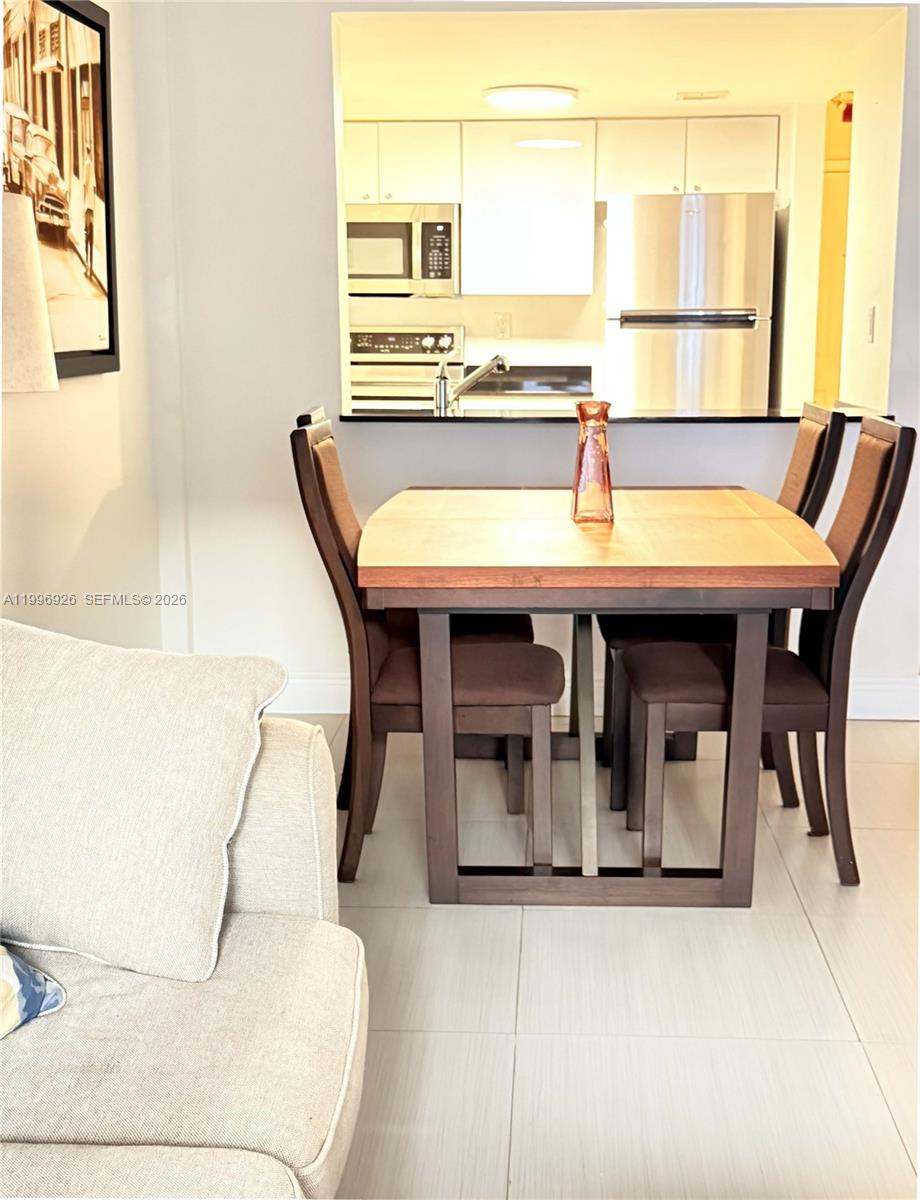 a dining table with chair and window