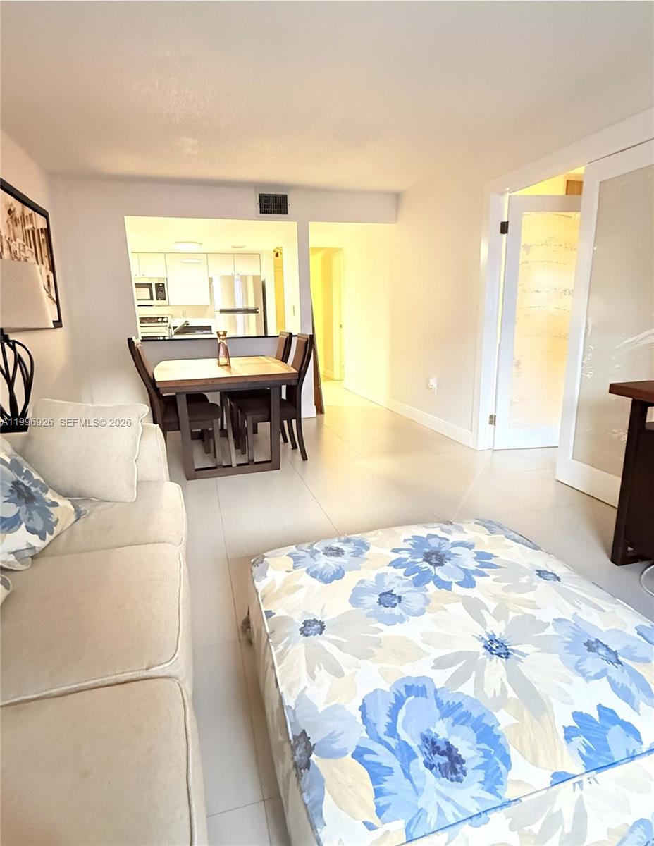 6801 Harding Avenue, Unit 301 Miami Beach, FL 33141 - Photo 2 of 10 a bedroom with a bed and a couch