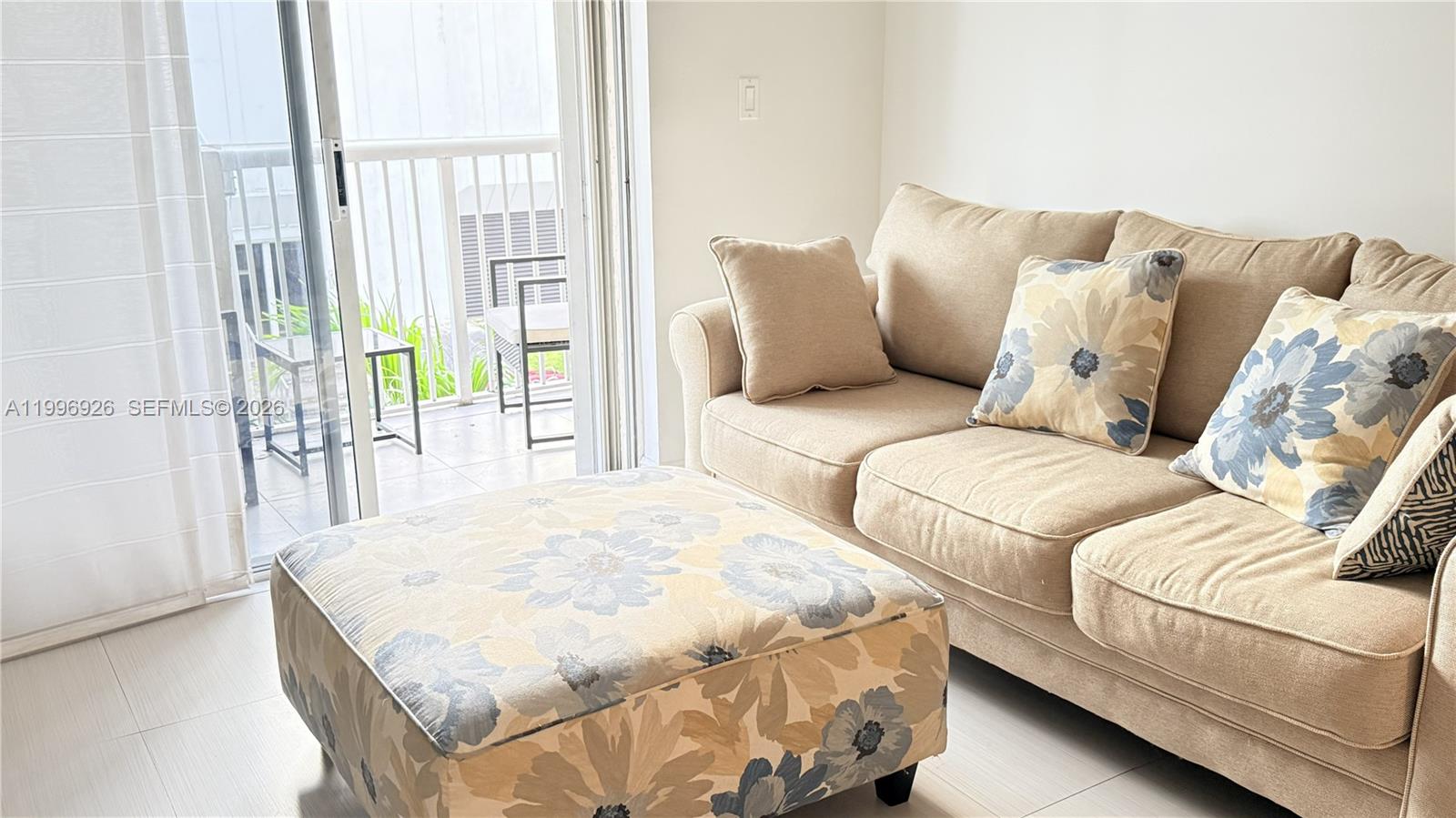 6801 Harding Avenue, Unit 301 Miami Beach, FL 33141 - Photo 10 of 10 a living room with a bed and a couch