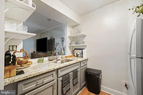 a kitchen with a sink appliances and cabinets