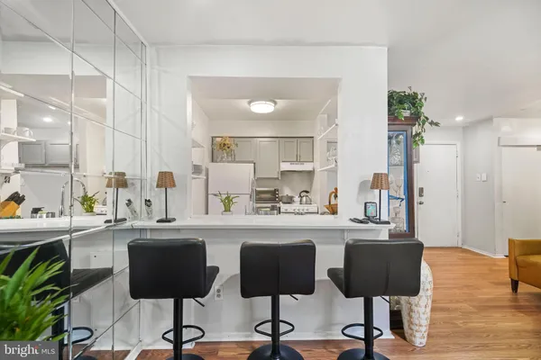 a kitchen with stainless steel appliances kitchen island granite countertop a table and chairs in it