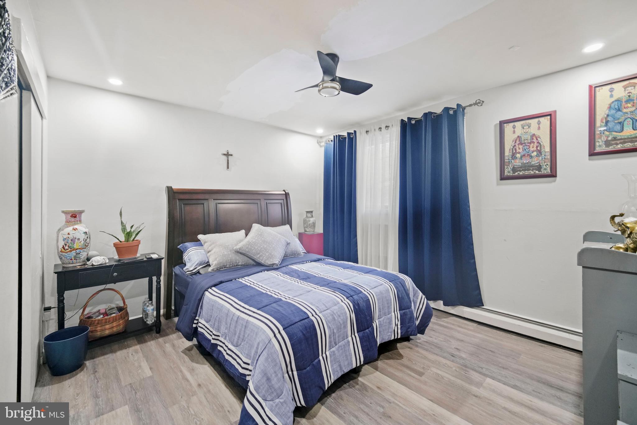 8115 West Chester Pike, Unit A8 Upper Darby, PA 19082 - Photo 15 of 17 a bedroom with a bed and a chandelier