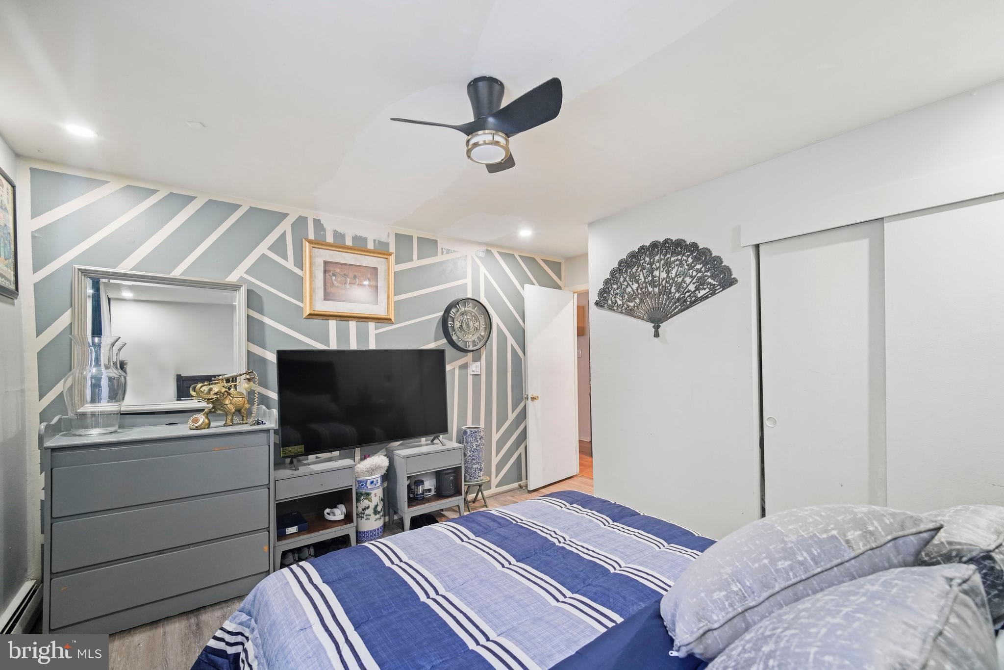 8115 West Chester Pike, Unit A8 Upper Darby, PA 19082 - Photo 16 of 17 a bedroom with a bed and a flat screen tv