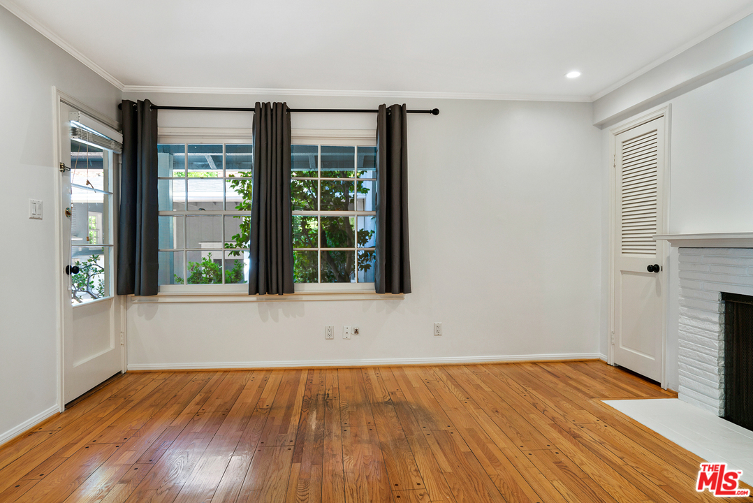 9601 Bolton Road Los Angeles, CA 90034 - Photo 12 of 33 a view of an empty room with wooden floor and a window