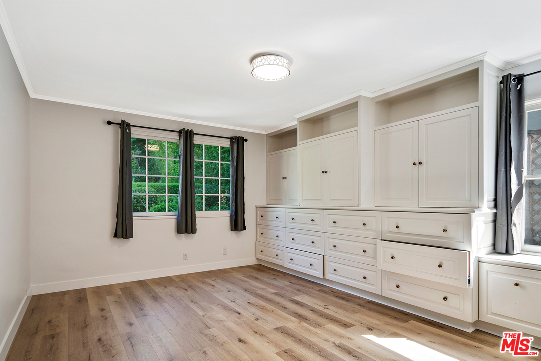 9601 Bolton Road Los Angeles, CA 90034 - Photo 14 of 33 a view of a bedroom with wooden floor and cabinet