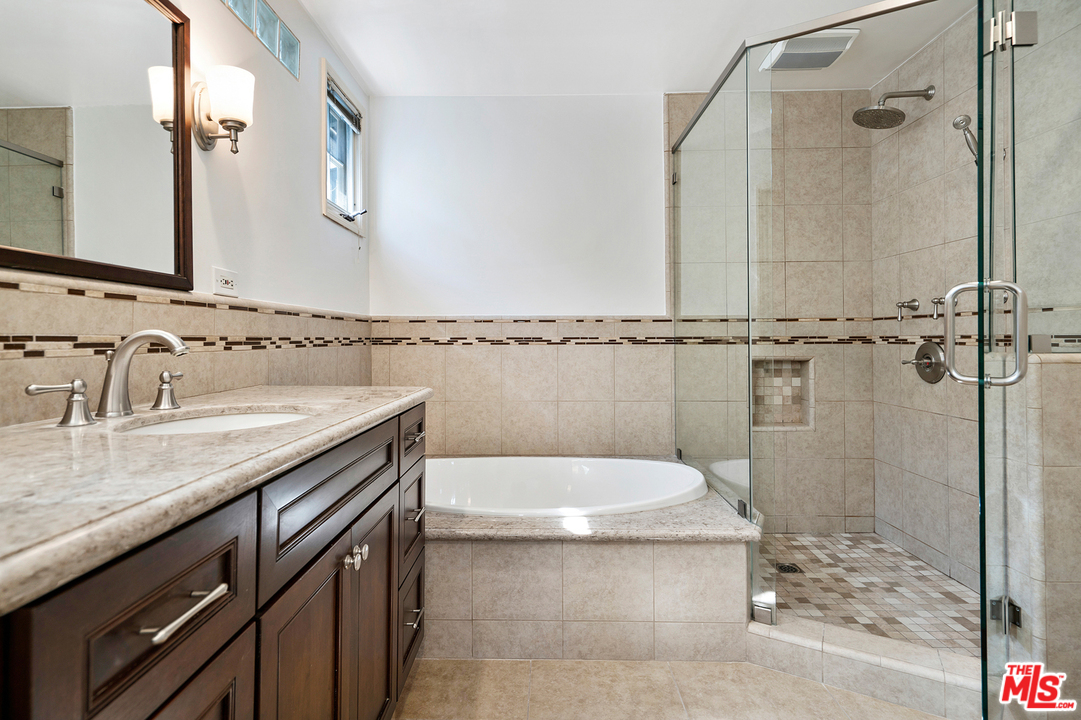 9601 Bolton Road Los Angeles, CA 90034 - Photo 15 of 33 a bathroom with a granite countertop sink a toilet and shower