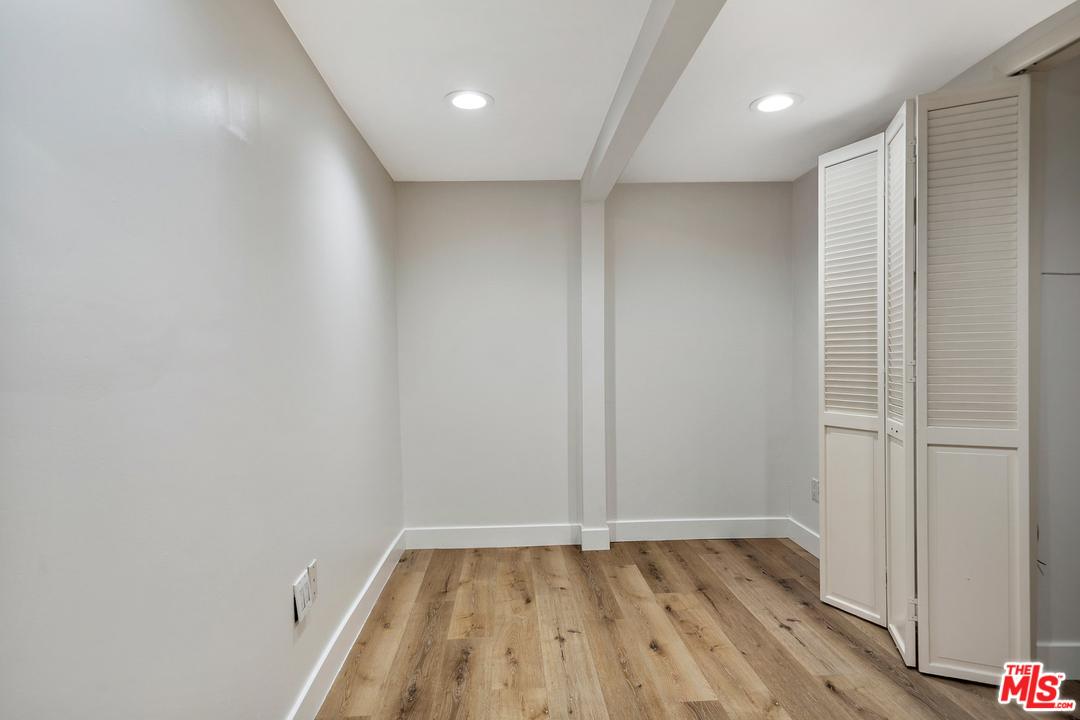 9601 Bolton Road Los Angeles, CA 90034 - Photo 17 of 33 a view of an empty room with wooden floor
