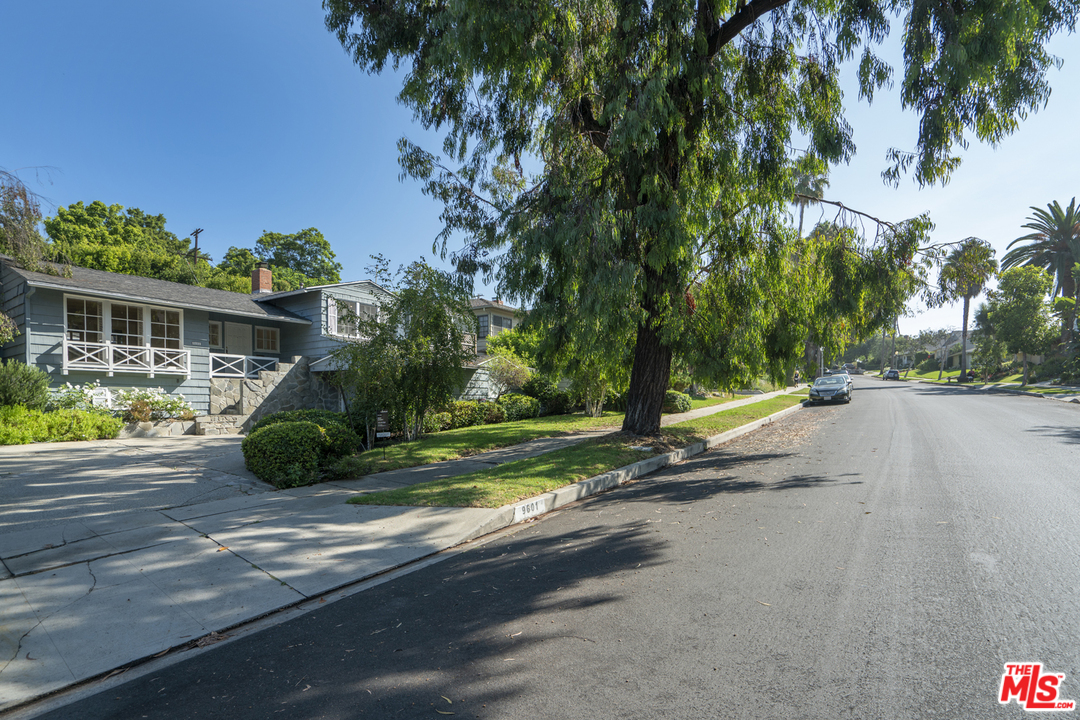 9601 Bolton Road Los Angeles, CA 90034 - Photo 2 of 33 a view of street with houses and trees