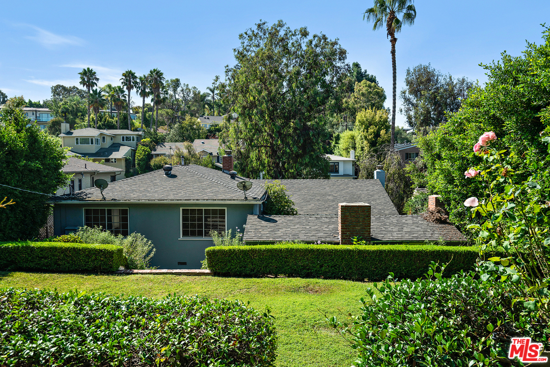 9601 Bolton Road Los Angeles, CA 90034 - Photo 28 of 33 a front view of a house with a garden