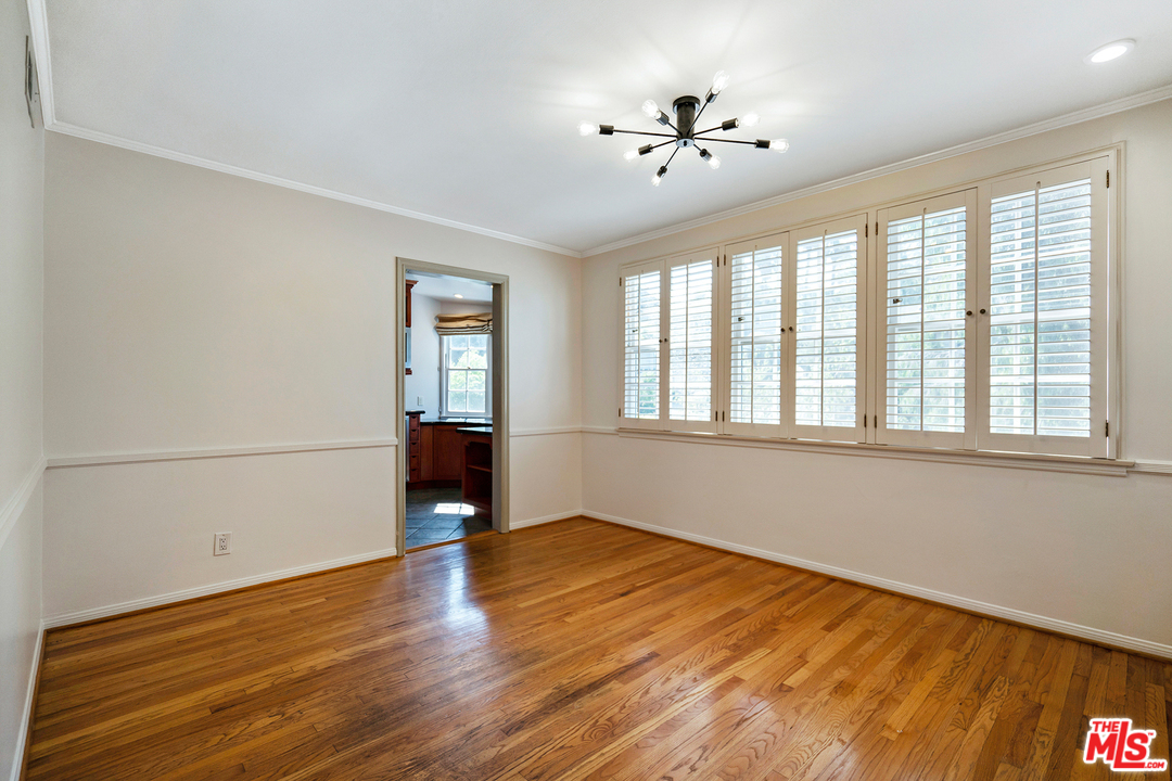 9601 Bolton Road Los Angeles, CA 90034 - Photo 10 of 33 a view of empty room with wooden floor and fan