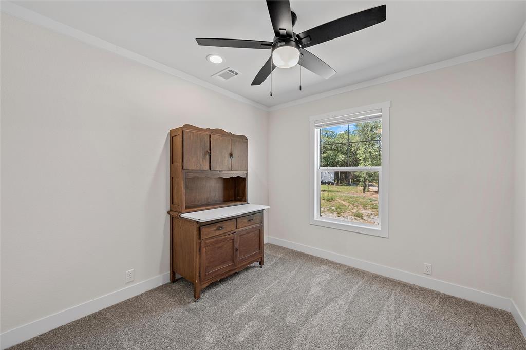 3050 Clater Powell Road Waco, TX 76705 - Photo 28 of 39 an empty room with windows and cabinet
