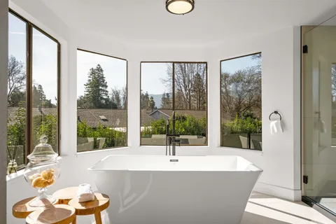 a living room with a large window and a floor to ceiling window