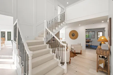 a view of entryway and hall with wooden floor