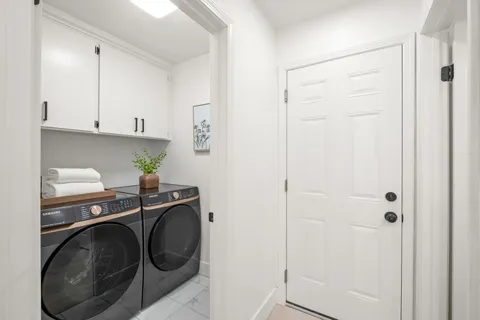 a utility room with sink dryer and washer