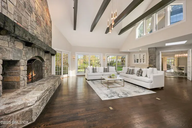 a living room with fireplace furniture and a rug