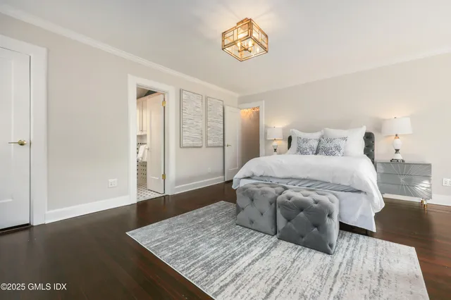 a spacious bedroom with a bed and a table in it