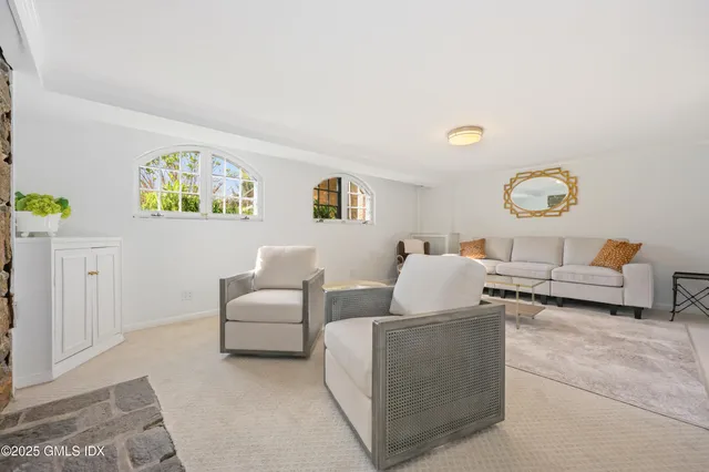 a living room with furniture and painting on the wall