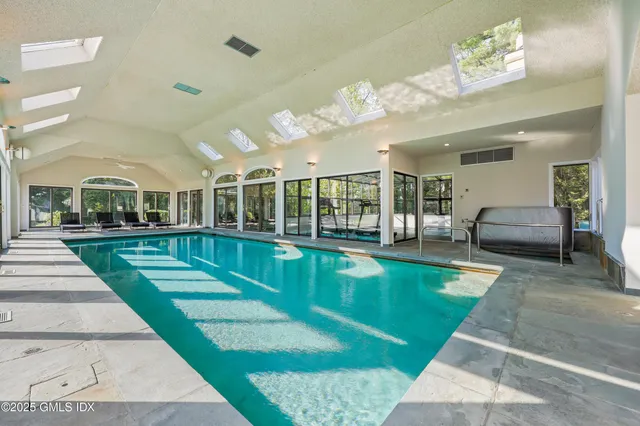 a view of a hall with floor to ceiling window and stairs