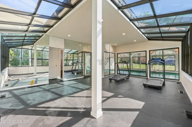 a view of an entryway with floor to ceiling windows