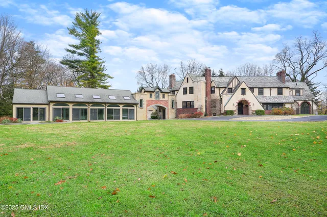 an aerial view of a house with swimming pool and outdoor space