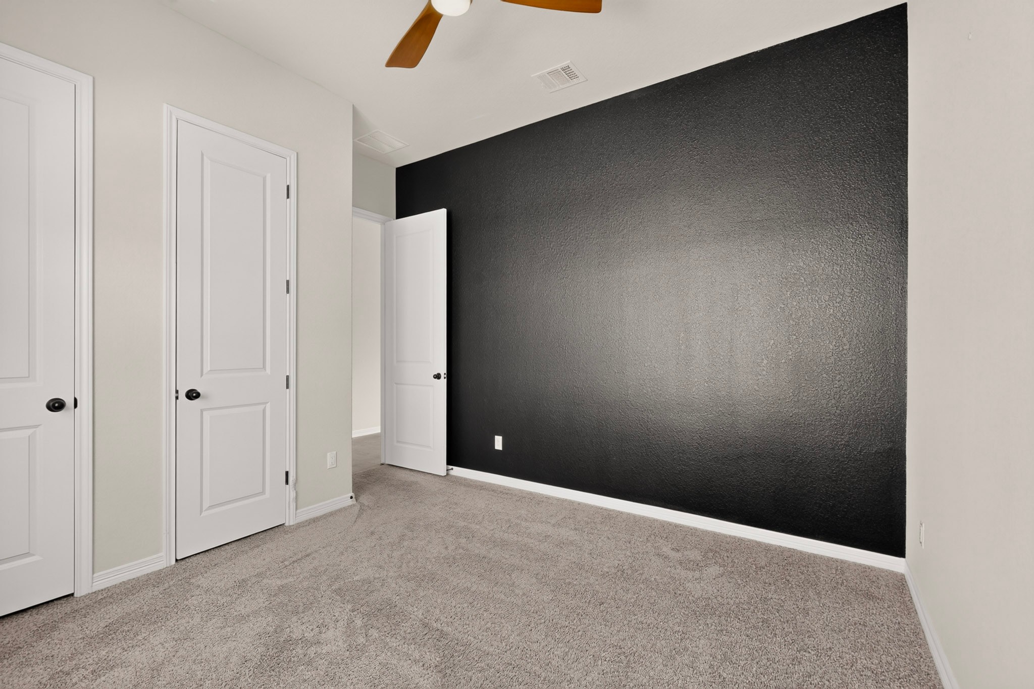 2433 La Mirada Street Leander, TX 78641 - Photo 13 of 25 A well-lit bedroom with soft carpeting provides a serene retreat.