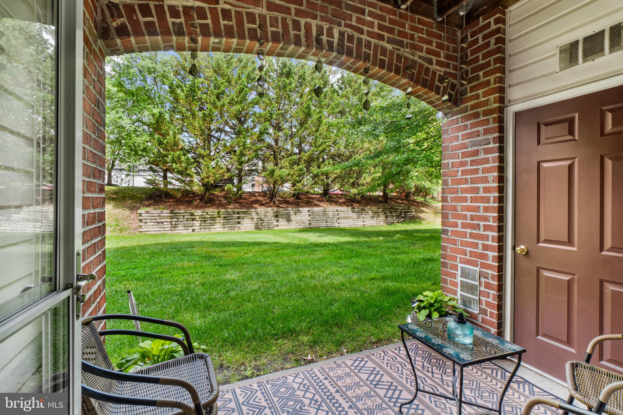 5144 Brightleaf Court, Unit 5144 Rosedale, MD 21237 - Photo 30 of 35 Charming patio with lush greenery