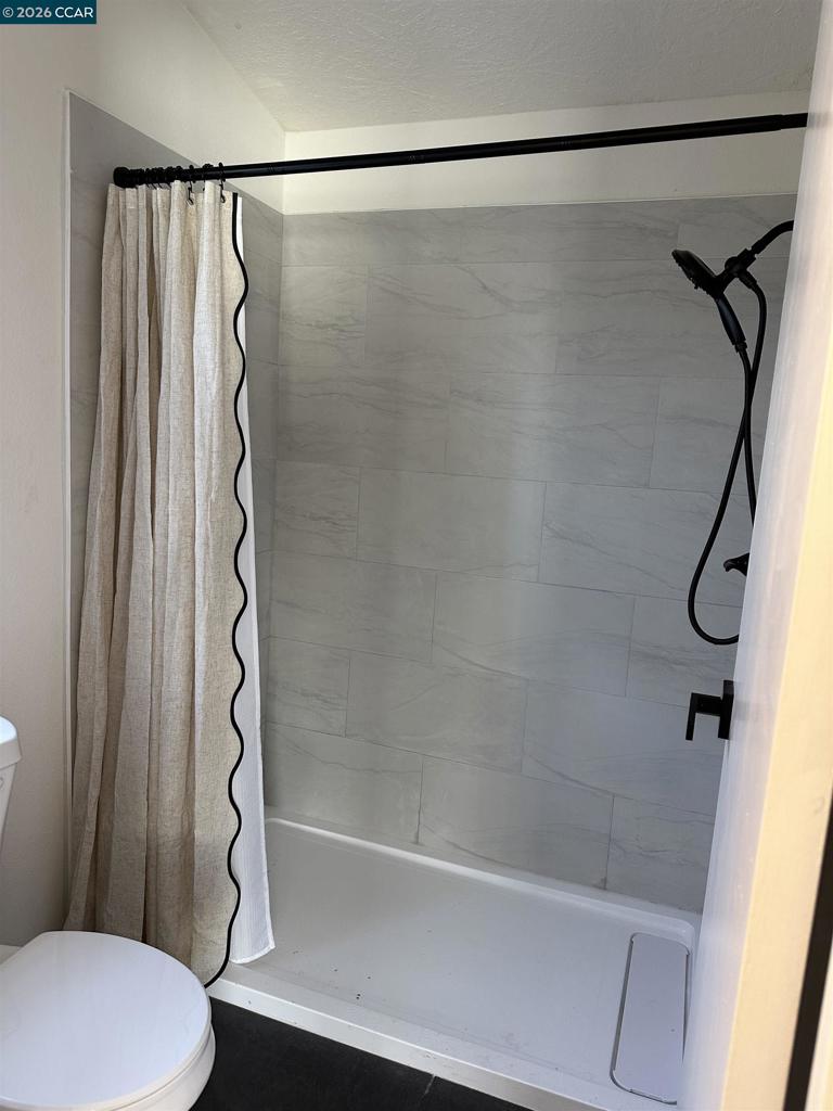 60 Wilson Way Milpitas, CA 95035 - Photo 12 of 22 a bathroom with a shower and a toilet
