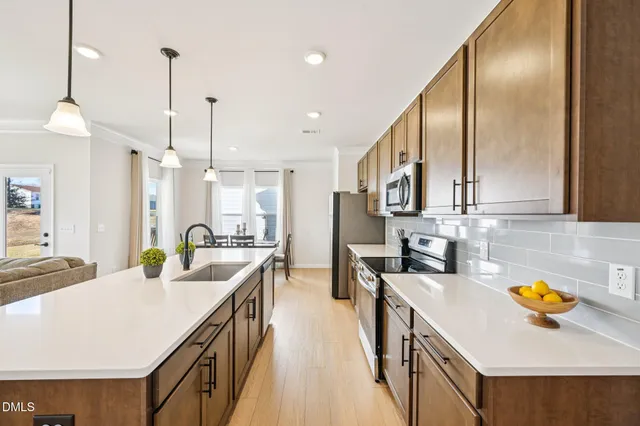 a kitchen with stainless steel appliances a sink a counter top space cabinets and furniture