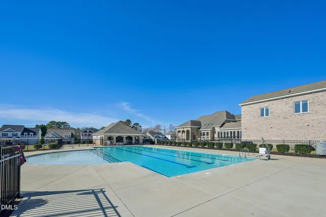 a view of a house with pool and a yard