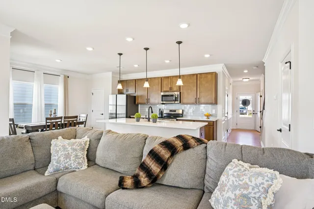 a living room with furniture and kitchen view