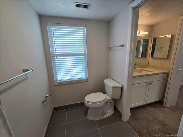 a bathroom with a toilet sink and a mirror